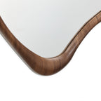 Wandspiegel mit organischer Form und braunem Holzrahmen